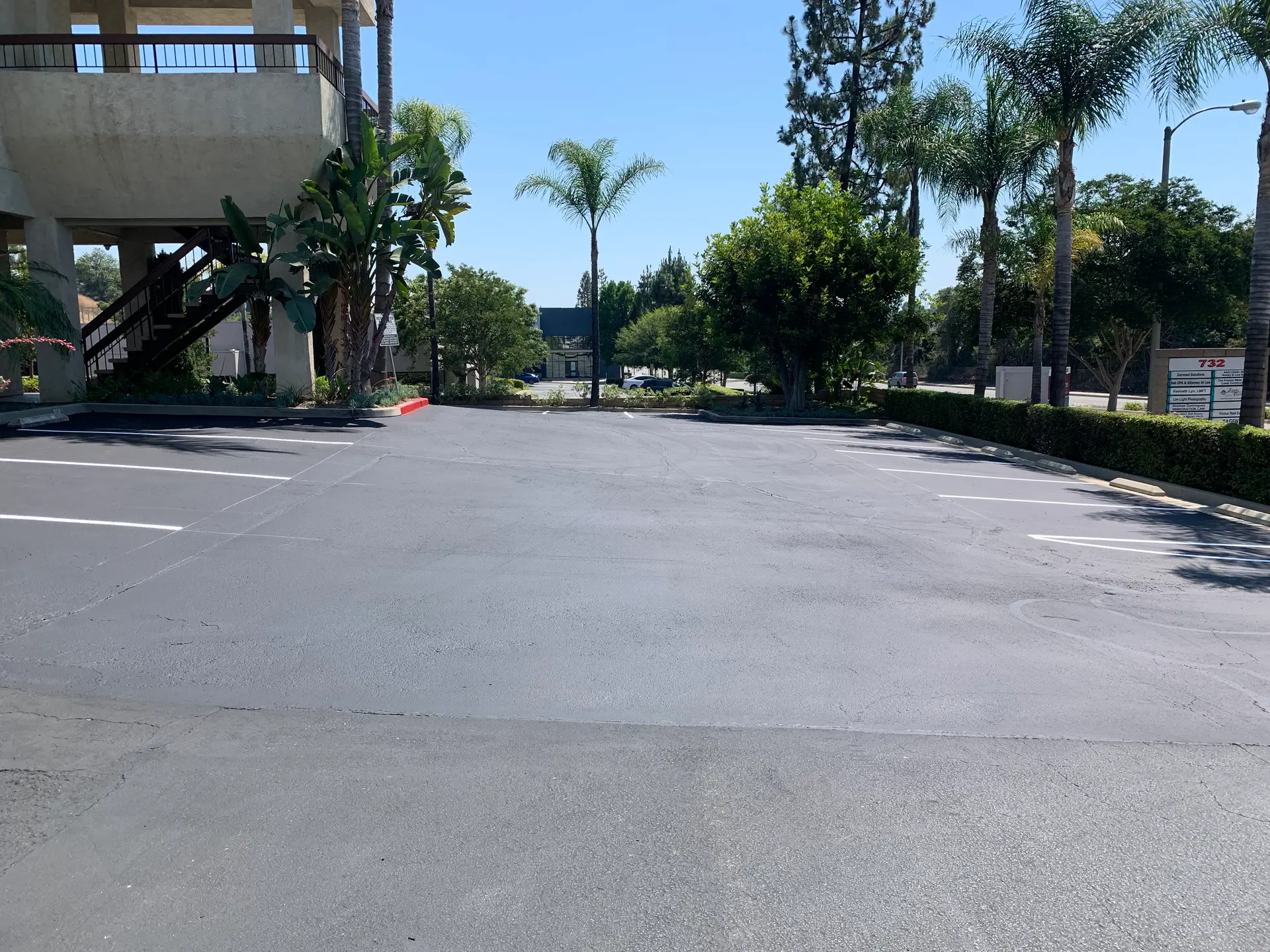 Seal coated asphalt with restored dark finish by Native Union Engineering
